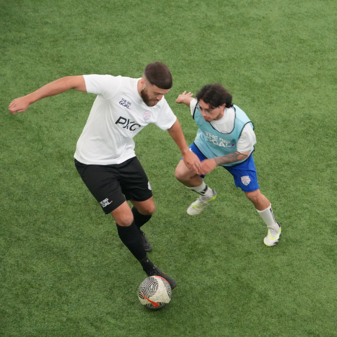 Two players playing football for The Big Goal project