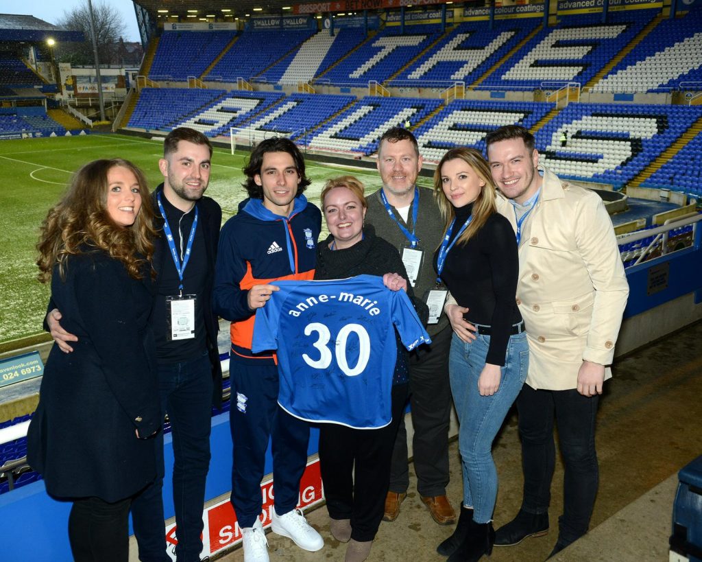 Group photo holding football t-shirt supporting the Anne Marie Purslow initiative