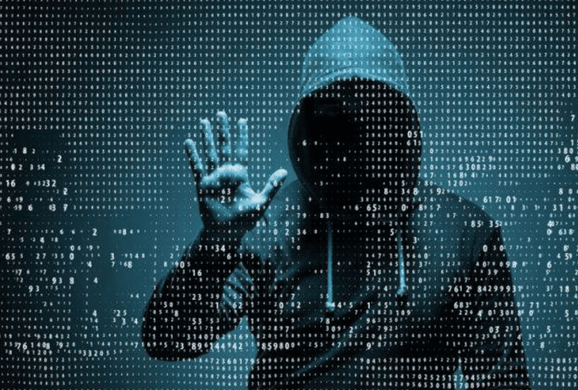 Unrecognizable person in a hoodie representing a hacker or cyber threat.