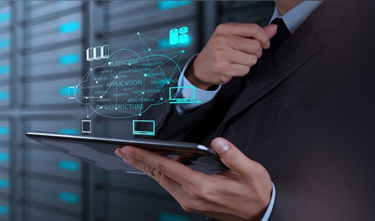 Man holding an ipad and abstract icons srepresenting the IT Nettwork